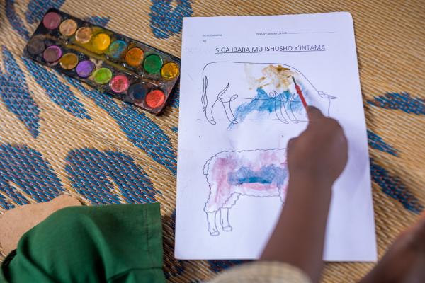 Joshua painting a picture of a cow.