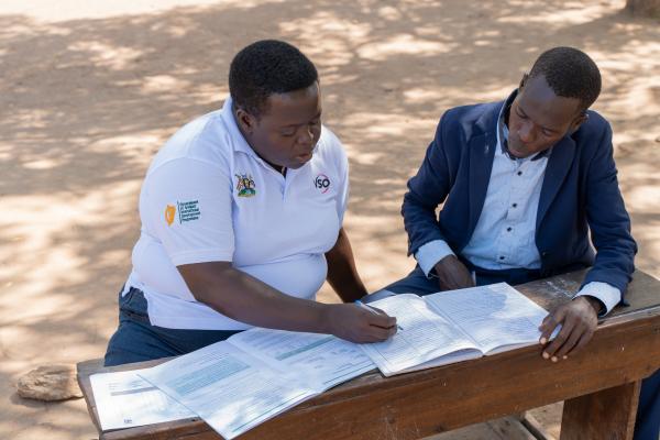VSO volunteer Semmy works with teacher Denis