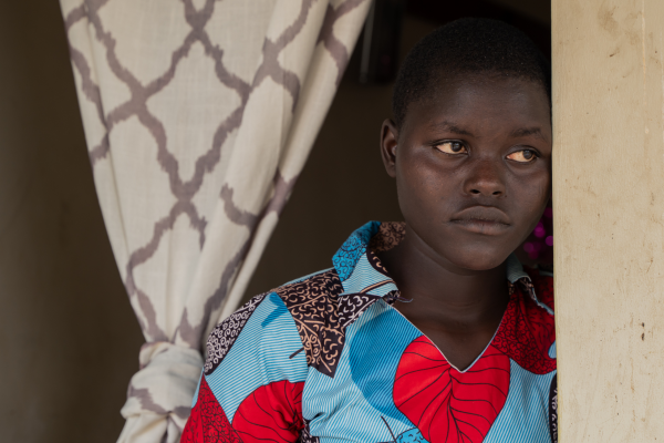 Emily stands outside her home