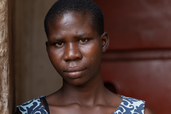 Juliet stands outside her home