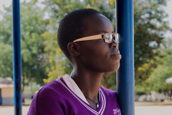 Alice stands outside her class