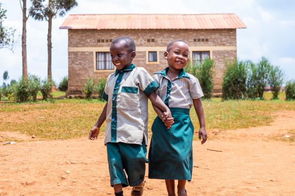 Joshua and Ella hold hands in school