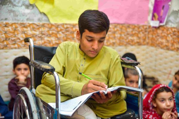 Sohail* reading at the learning centre
