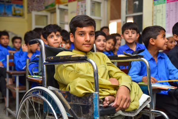 Sohail in his VSO provided wheelchair in the classroom.