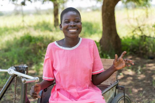 Nangiro in her wheelchair, smiling.
