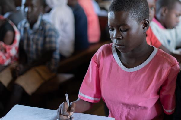 Nangiro sat at a desk, working in the classroom.