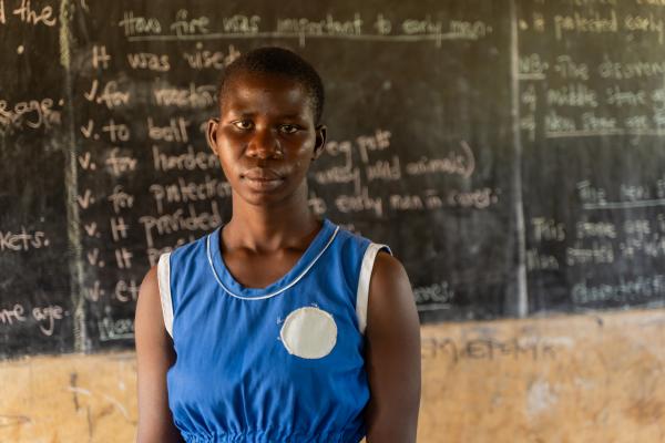 Student Juliet stood in front of a blackboard.