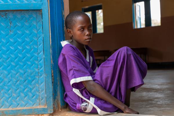Student Nakiru stood outside an empty classroom.