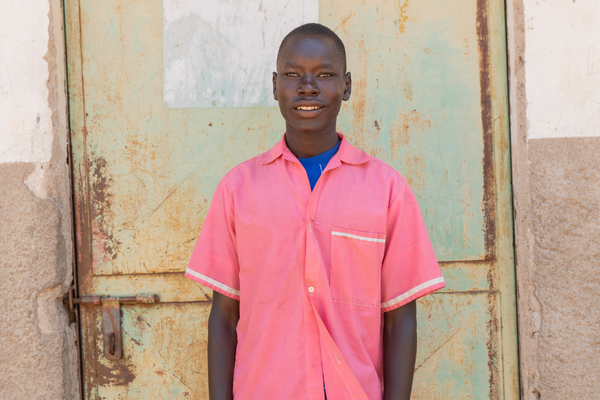 Student Patrick stood in the playground, wearing pink uniform.