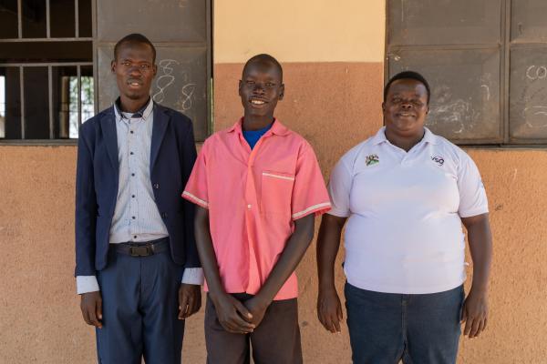 Teacher Denis, student Patrick and VSO volunteer Semmy.