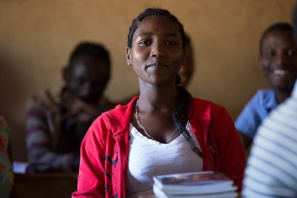 Zena Boko, Age 16, Grade 8, She currently lives in the village, but her parents live in Dilla with other displaced people. Zena Boko, Age 16, Grade 8, smiles sitting in class having returned to school.