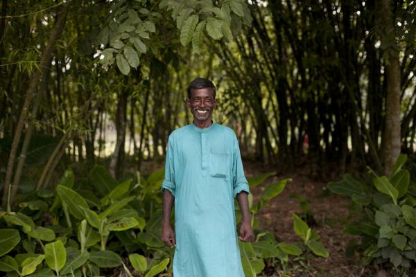 Abdul Latif, pictured here standing outdoors, is a farmer working with VSO on the Growing Together project.