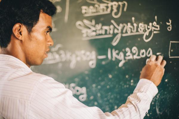 Teacher at a blackboard in Cambodia