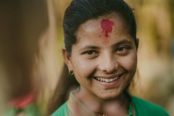 A young Nepalese girl smiling to the camera