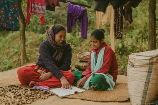 A young girl being tutored by her Big Sister, Rama