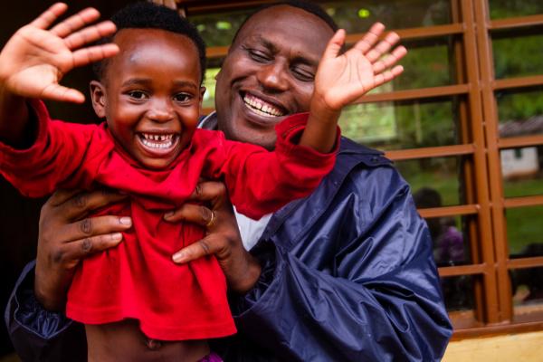 Habumugisha Daniel with VSO staff member Claude Kamba. Daniel attends an early childhood education class in Rwamatamu, based in one of the poorest districts in Rwanda. 