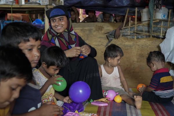 Rohingya mother and children enjoying an education session