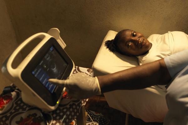 Mamie Momoh, 21, who is nine months pregnant, observes as she is scanned for the first time at Kamaranka Community Health Centre Mamie Momoh, 21, who is nine months pregnant, observes as she is scanned for the first time at Kamaranka Community Health Centre
