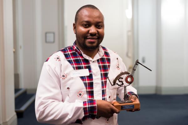 Harrison with his trophy at the VSO Volunteer Impact Awards Harrison with his trophy at the VSO Volunteer Impact Awards