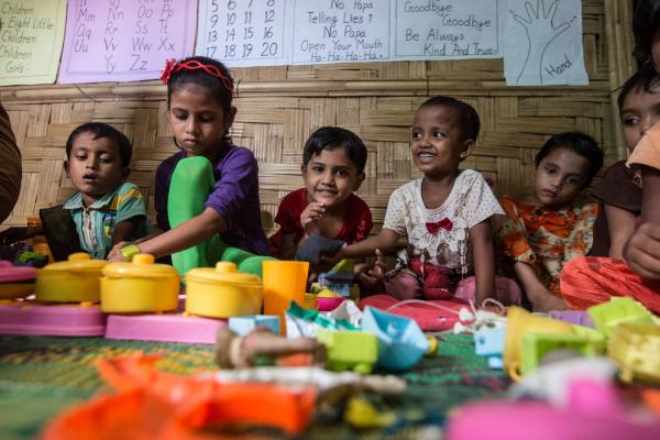Rohingya children playing with toys in a learning centre in Cox's Bazar refugee camp, Bangladesh.