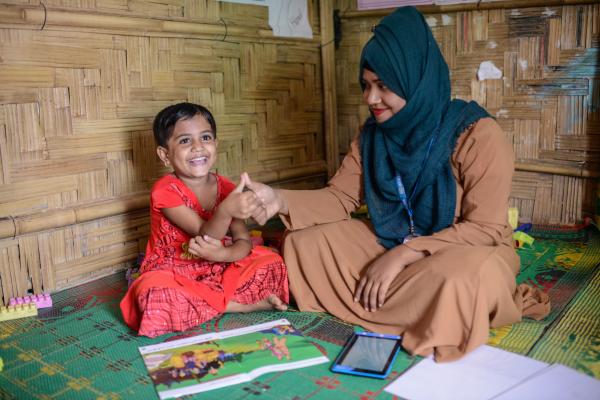 Mabia, 5, at the ECCE centre – 31, supported by VSO, with supervisor Muslima Zannat Rima, the centre is situated at Camp 15 in Jamtoli of Ukhiya, Cox's Bazar, Bangladesh.