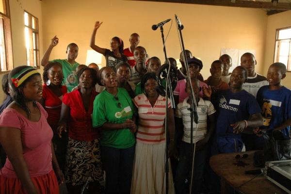 a group of people in a room with microphones singing