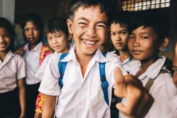 A group of young schoolchildren laugh together