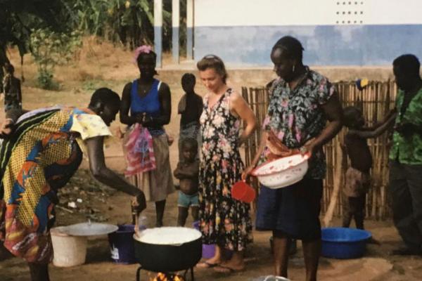 On her placement, Elaine was the only English speaker Elaine and volunteers cooking outside