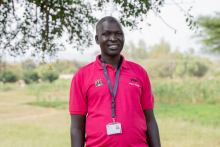 VSO volunteer Alfred, smiling at the camera.